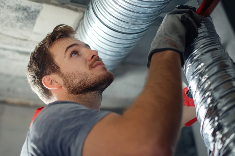 Technician Cleaning Air Duct